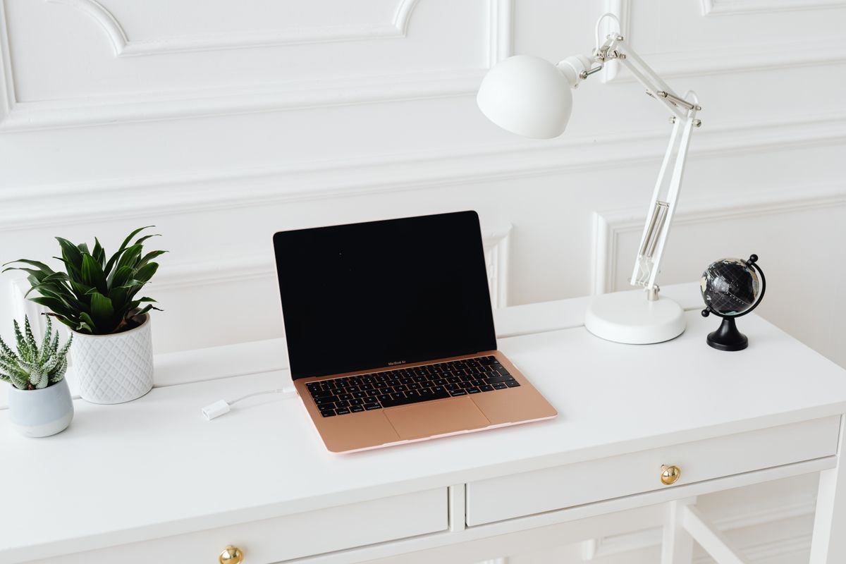 Laptop på ljust skrivbord i hemmiljö